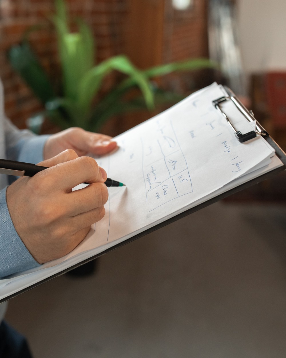 Reviewing a job checklist on a clipboard, illustrative stock photo